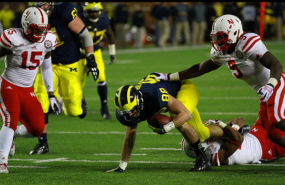 Graham Glasgow (61), Derrick Green (27), and Jake Butt (88)