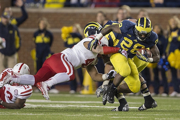 Taylor Lewan (77) and Fitzgerald Toussaint (28)