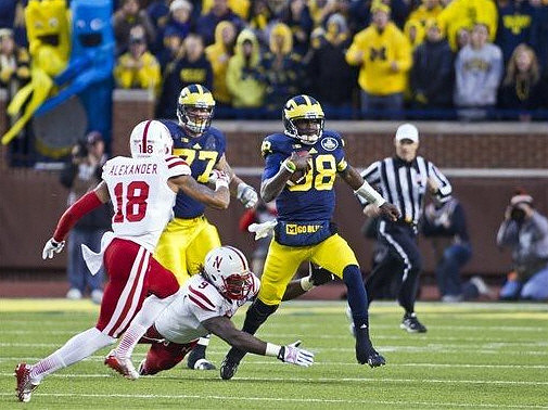 Taylor Lewan (77) and Devin Gardner (98)