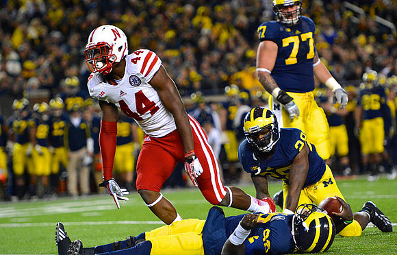 Devin Gardner (98), Fitzgerald Toussaint (28), and Taylor Lewan (77)
