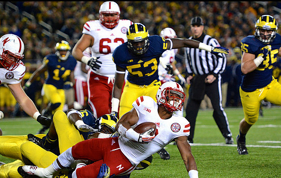 Josh Furman (14), Mario Ojemudia (53), Quinton Washington (76), and Joe Bolden (35)