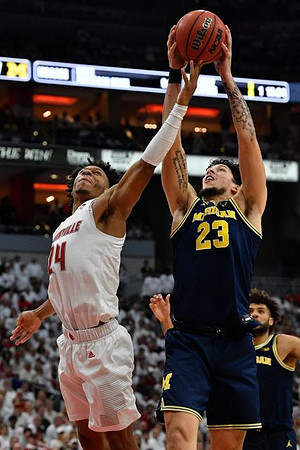 Brandon Johns Jr. (23) and Isaiah Livers (2)