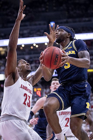 Jon Teske (15) and Zavier Simpson (3)