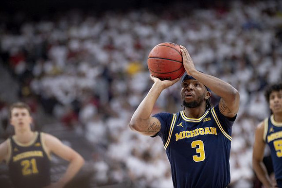 Franz Wagner (21), Zavier Simpson (3), and Eli Brooks (55)