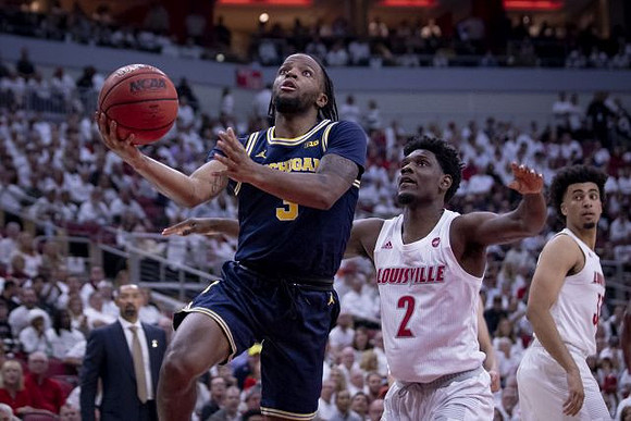Zavier Simpson (3) and Juwan Howard