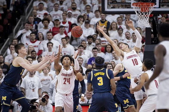 Colin Castleton (11), Zavier Simpson (3), and Franz Wagner (21)