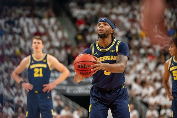Franz Wagner (21), Zavier Simpson (3), and Eli Brooks (55)