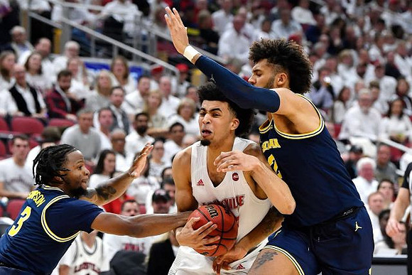 Zavier Simpson (3) and Isaiah Livers (2)