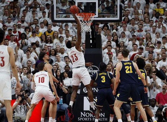 Brandon Johns Jr. (23), Zavier Simpson (3), Franz Wagner (21), and Eli Brooks (55)