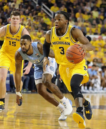Jon Teske (15) and Zavier Simpson (3)