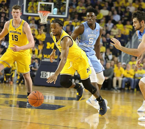 Jon Teske (15) and Zavier Simpson (3)