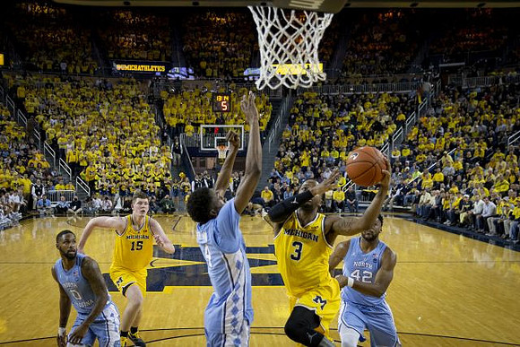 Jon Teske (15) and Zavier Simpson (3)