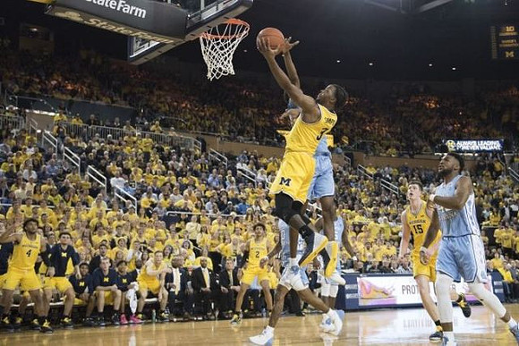 Zavier Simpson (3), Isaiah Livers (4), Jordan Poole (2), and Jon Teske (15)