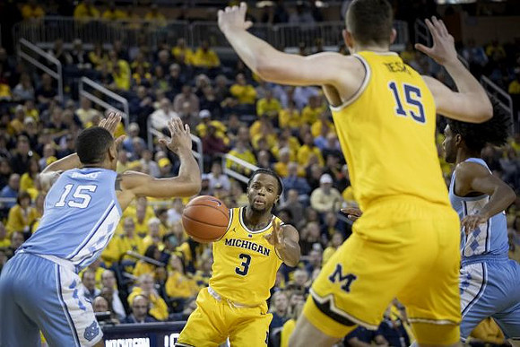 Zavier Simpson (3) and Jon Teske (15)
