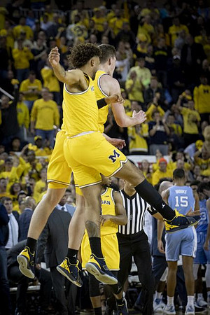 Isaiah Livers (4), Jon Teske (15), and Zavier Simpson (3)