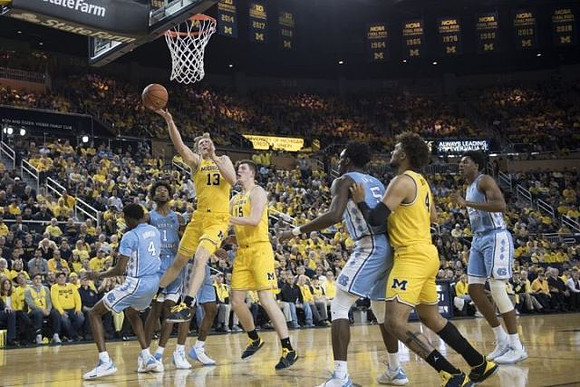 Ignas Brazdeikis (13), Jon Teske (15), and Isaiah Livers (4)