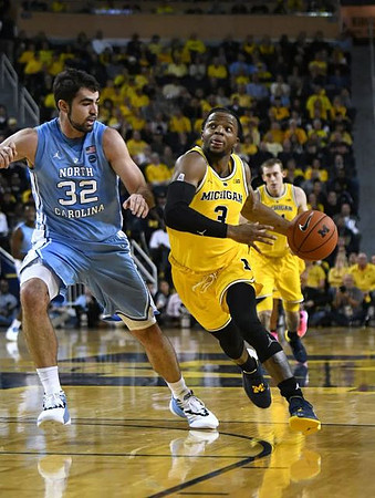 Zavier Simpson (3) and Austin Davis (51)