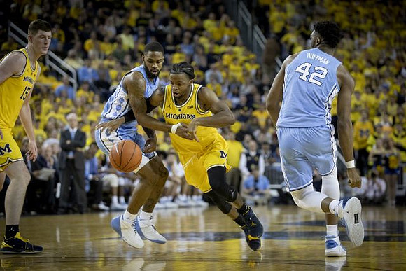 Jon Teske (15) and Zavier Simpson (3)