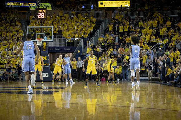 Jon Teske (15), Ignas Brazdeikis (13), Zavier Simpson (3), and Isaiah Livers (4)
