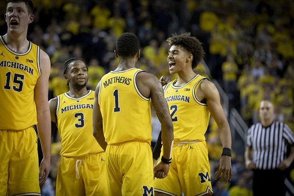 Jon Teske (15), Zavier Simpson (3), Charles Matthews (1), and Jordan Poole (2)