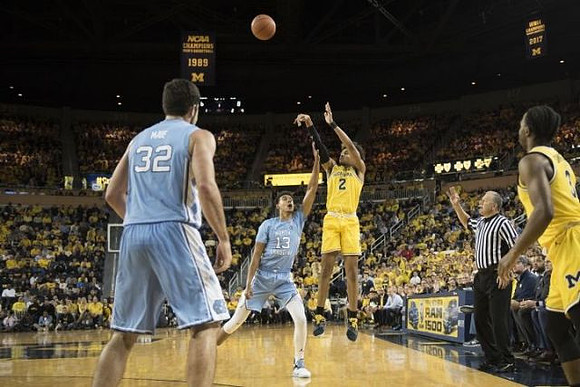 Jordan Poole (2) and Zavier Simpson (3)