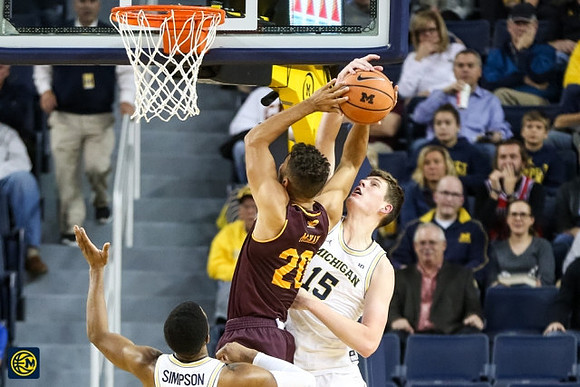 Zavier Simpson (3) and Jon Teske (15)