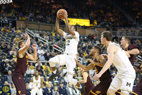 Zavier Simpson (3), Muhammad-Ali Abdur-Rahkman (12), and Jon Teske (15)