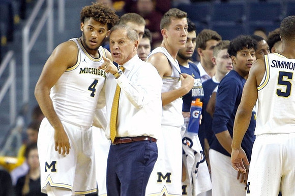 Isaiah Livers (4), John Beilein, Duncan Robinson (22), Eli Brooks (55), and Jaaron Simmons (5)