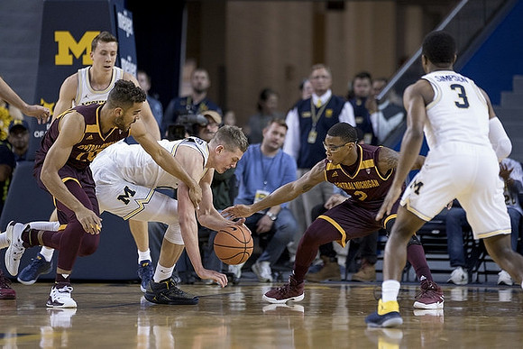 Duncan Robinson (22), Moritz Wagner (13), and Zavier Simpson (3)