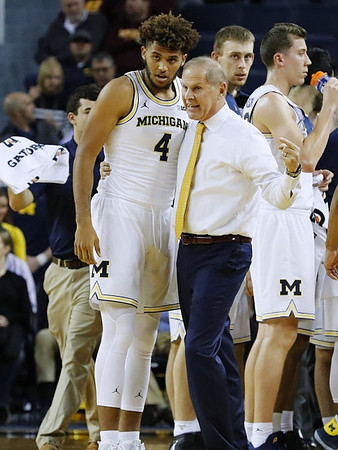 Isaiah Livers (4), John Beilein, and Duncan Robinson (22)