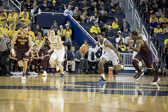 Duncan Robinson (22), Zavier Simpson (3), and Muhammad-Ali Abdur-Rahkman (12)