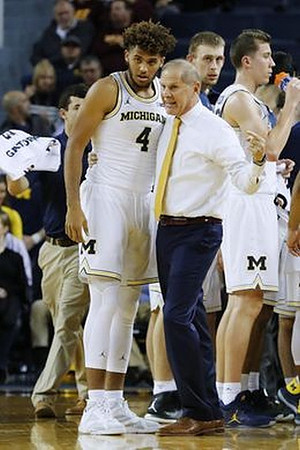 Isaiah Livers (4), John Beilein, and Duncan Robinson (22)