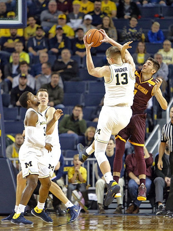 Zavier Simpson (3), Duncan Robinson (22), and Moritz Wagner (13)