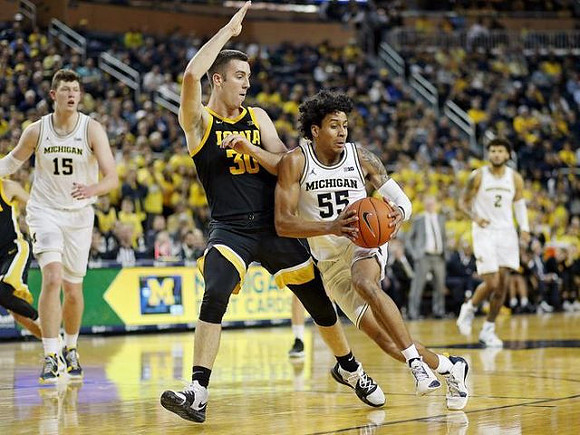 Jon Teske (15), Eli Brooks (55), and Isaiah Livers (2)