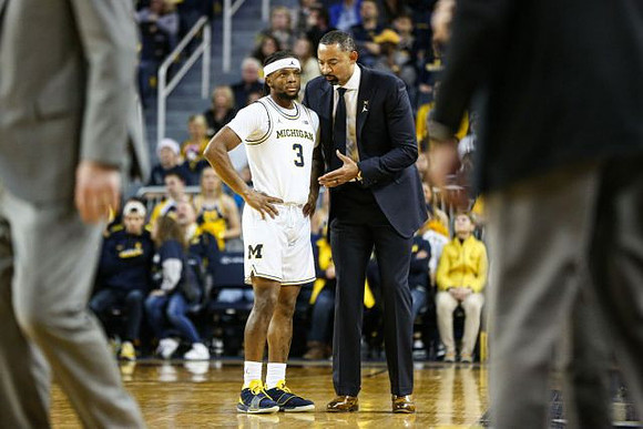 Zavier Simpson (3) and Juwan Howard