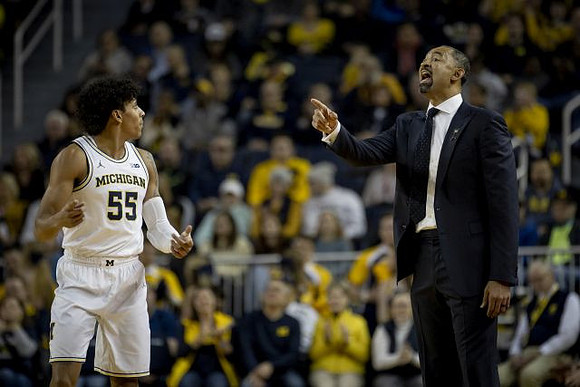 Eli Brooks (55) and Juwan Howard
