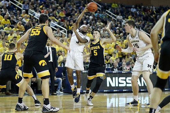 Zavier Simpson (3) and Jon Teske (15)