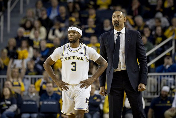 Zavier Simpson (3) and Juwan Howard