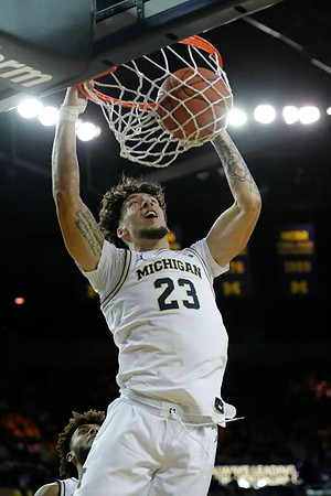 Brandon Johns Jr. (23) and Isaiah Livers (2)
