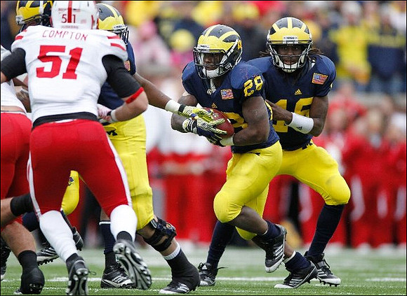 Fitzgerald Toussaint (28) and Denard Robinson (16)