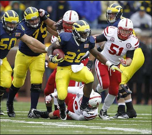 David Molk (50), Michael Schofield (75), Fitzgerald Toussaint (28), and Taylor Lewan (77)