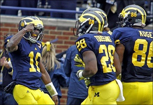 Denard Robinson (16), Fitzgerald Toussaint (28), and Kevin Koger (86)