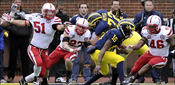 Mark Huyge (72) and Denard Robinson (16)