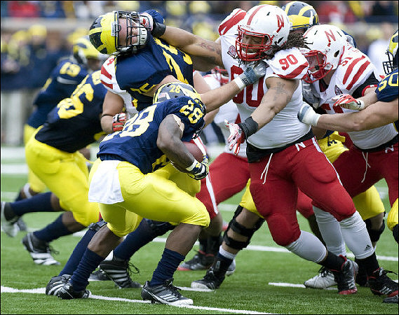 Kelvin Grady (19), Kevin Koger (86), Michael Schofield (75), Fitzgerald Toussaint (28), David Molk (50), and Taylor Lewan (77)