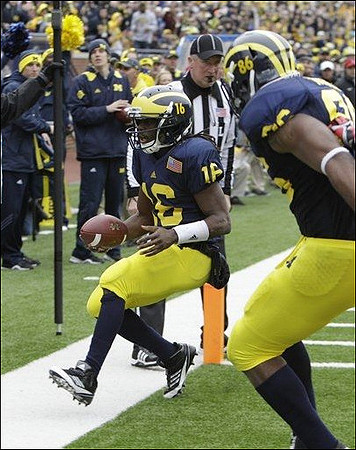 Denard Robinson (16) and Kevin Koger (86)