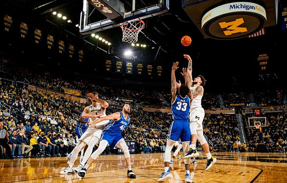 Hunter Dickinson (1) and Brandon Johns Jr. (23)