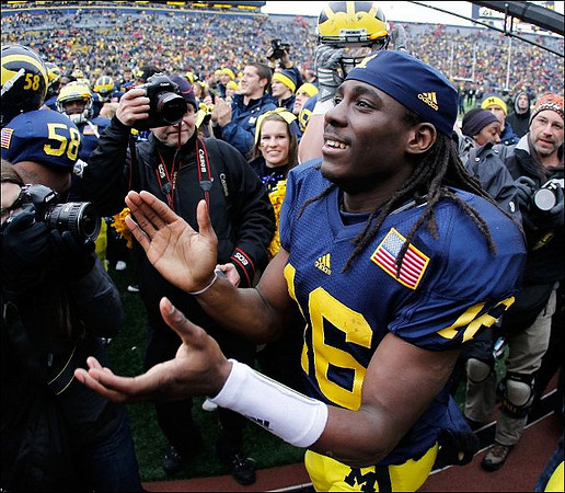 Brandon Herron (58) and Denard Robinson (16)