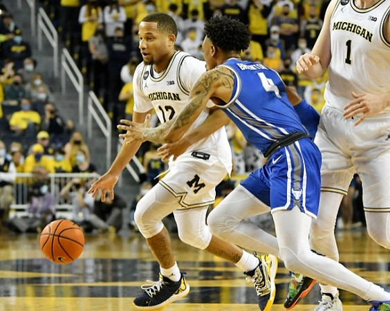 DeVante' Jones (12) and Hunter Dickinson (1)