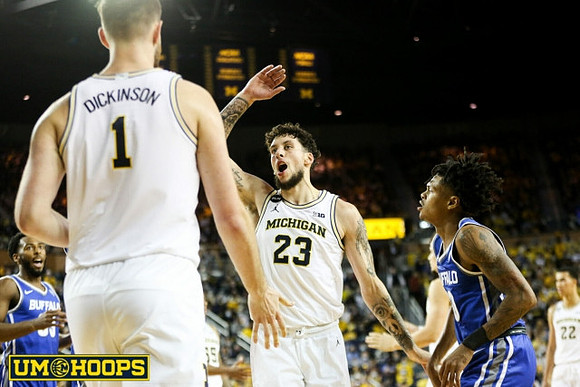 Hunter Dickinson (1) and Brandon Johns Jr. (23)