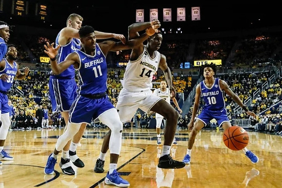Moussa Diabate (14) and DeVante' Jones (12)